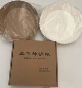 Round white disposable parchment paper liner for air fryer basket with raised edges.