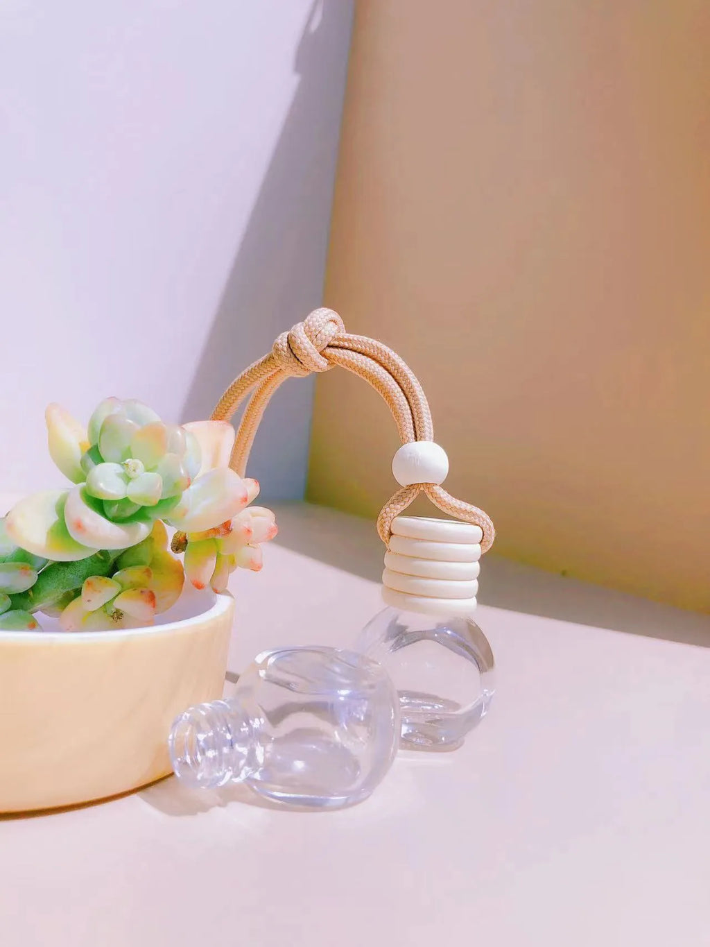 Glass car perfume pendant air freshener in cylinder, diamond, flat drum, and square shapes.