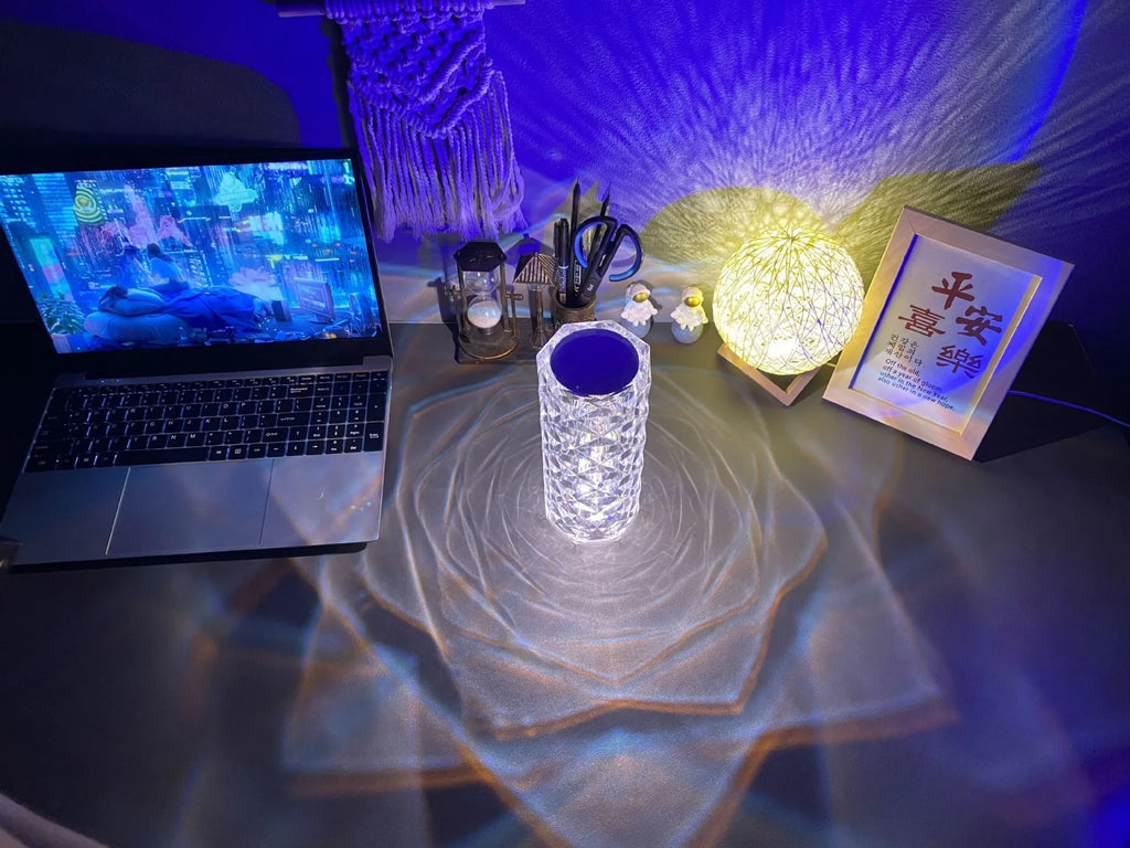 LED rose diamond shaped table lamp with acrylic construction and three-tone lighting on a wooden surface.