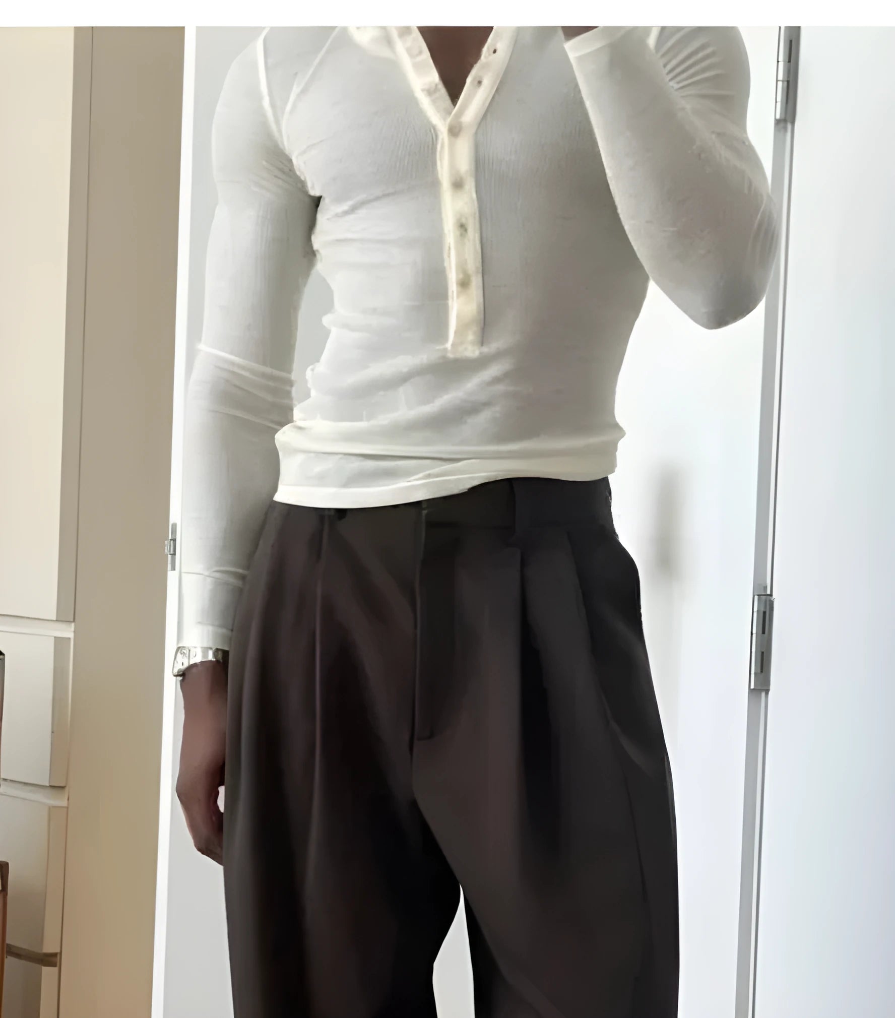 Men's cream coloured ribbed long-sleeve henley top with buttoned placket.