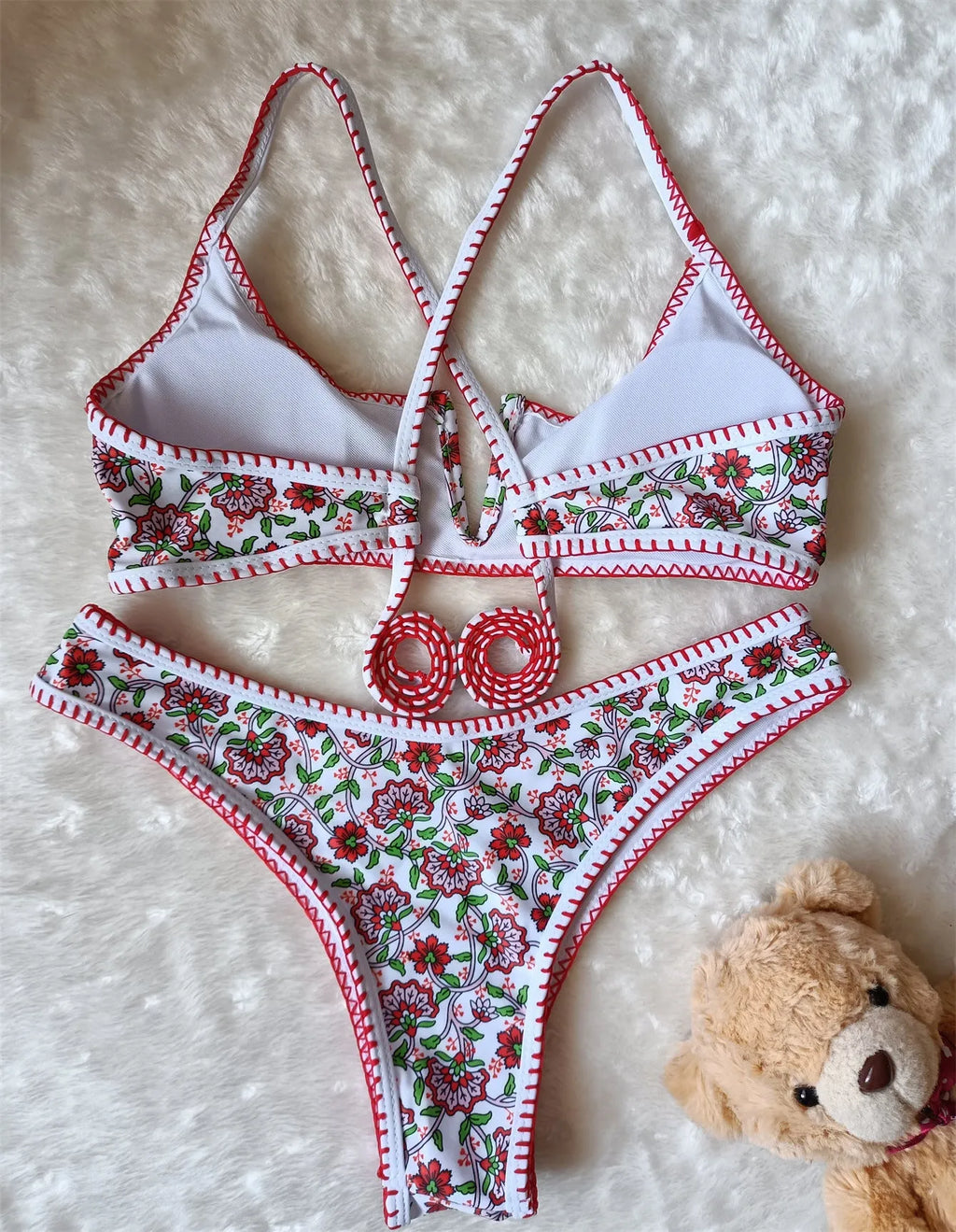 Women's V-neck swimsuit with floral embroidery in polyester fabric showing brief style cut