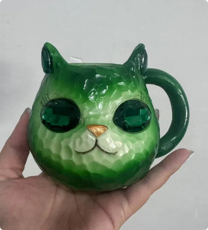 Colourful resin Crystal Earth Cat Cup craft decorative gift on a table.