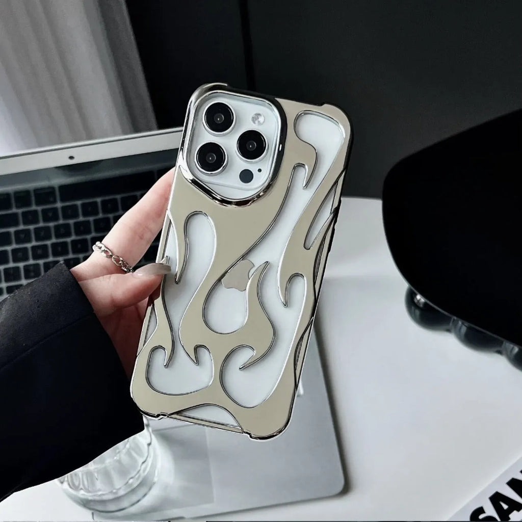 Electroplated hollow flame pattern soft TPU phone case for Apple iPhone on a table.