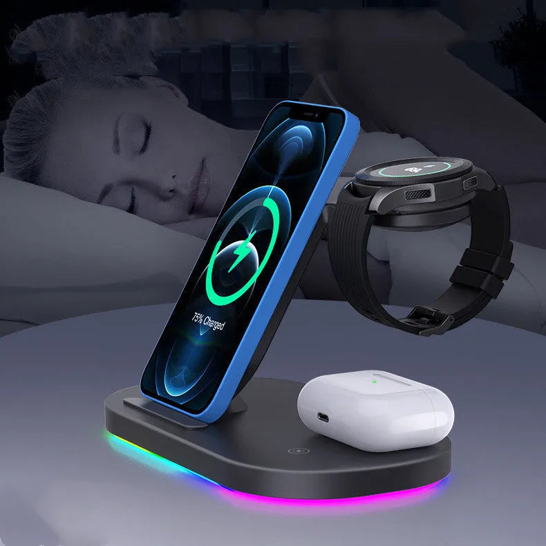 Three-in-one wireless charging station in black, charging a mobile phone, a smartwatch, and wireless headphones.