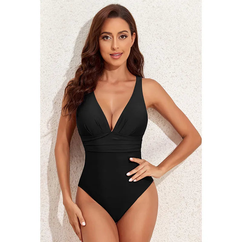 Women's solid colour cross-shoulder one-piece swimsuit in minimalist design for swimming activities