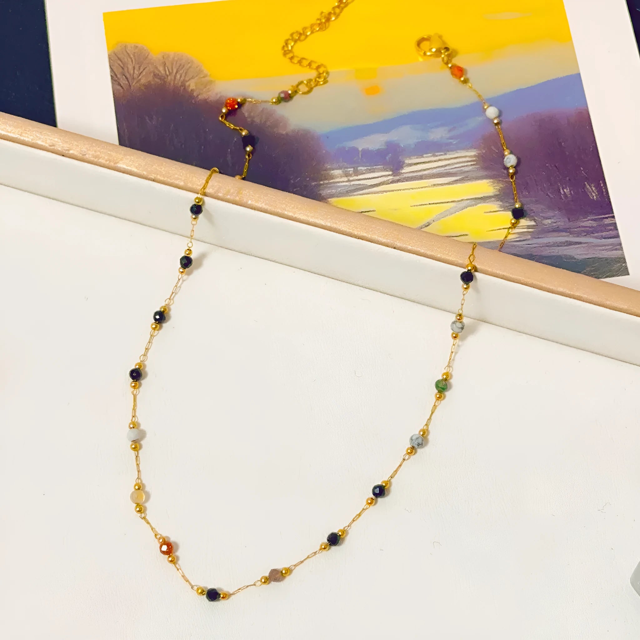 Gold titanium steel necklace with a natural stone pendant on an O-ring chain.
