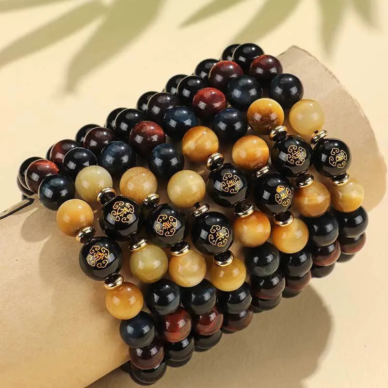 Black agate beaded bracelet with carved Buddhist charm and tiger eye stones