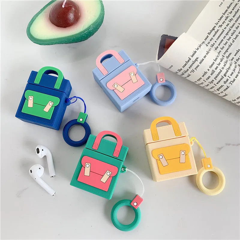 Silicone protective sleeve for AirPods 1 and 2 charging case with hanging ring, available in dark blue, green, purple, and yellow colours