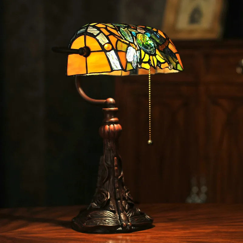 10-inch Tiffany stained glass table lamp with multicoloured glass and resin base on desk
