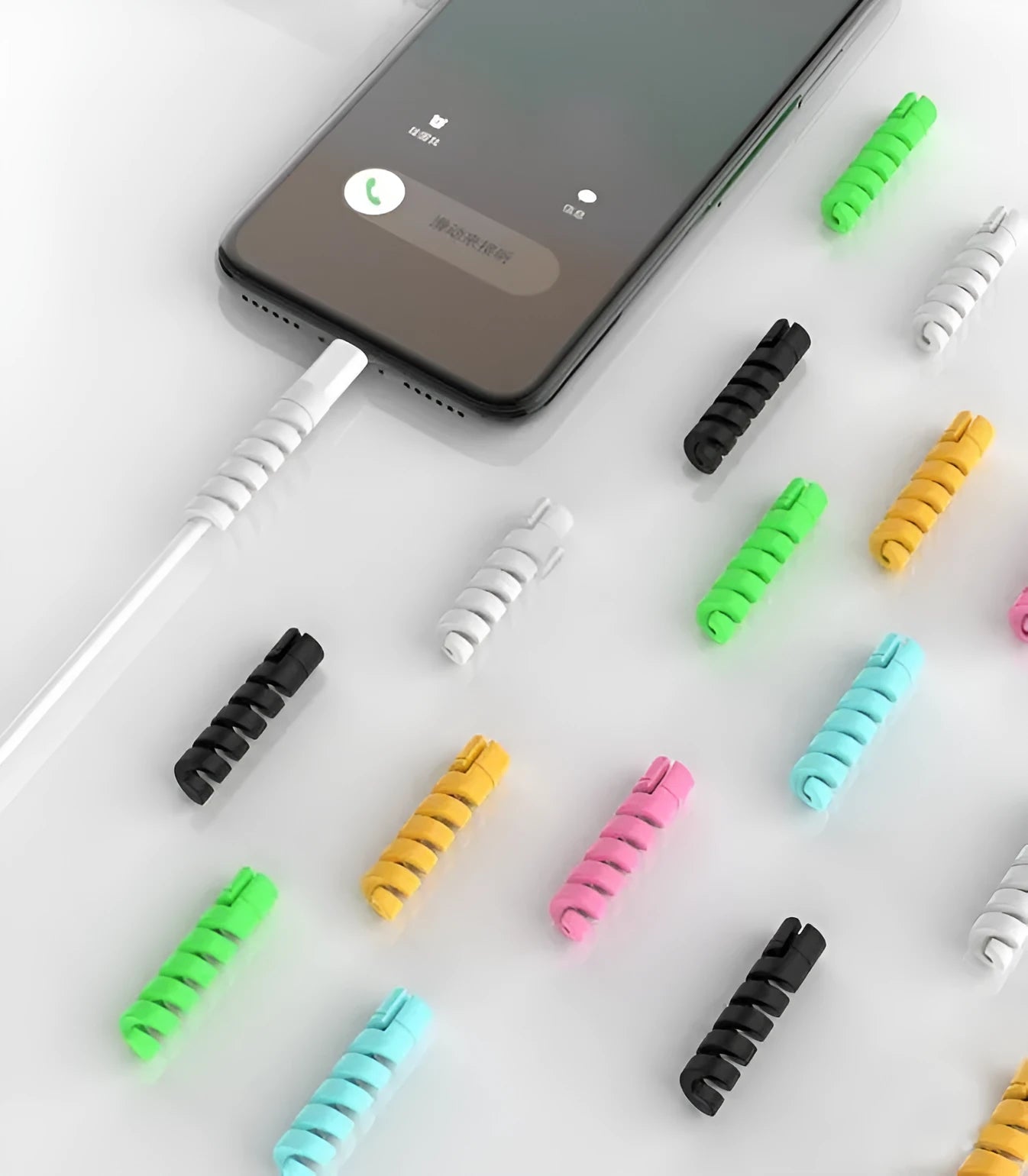 Plastic charging cable protector in various colours, shown next to a USB cable.