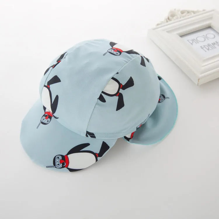 Boys' blue penguin print swim set with long sleeve swimsuit and matching swimming cap