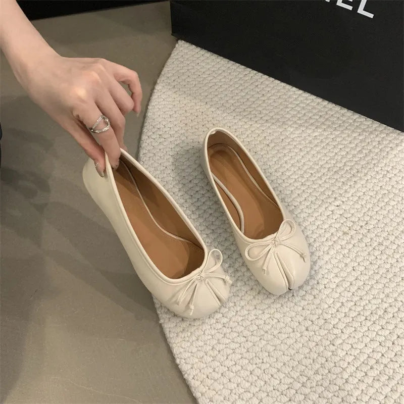 Women's split-toe flat pump shoes in beige with a round toe and shallow cut.