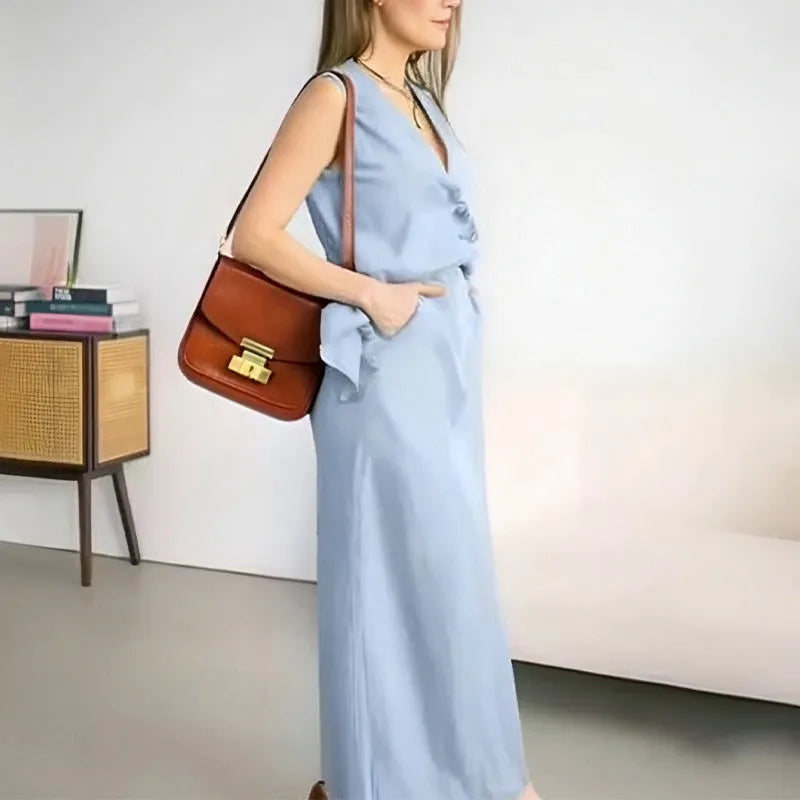 White casual women's two-piece set with sleeveless loose vest and long flowing skirt on a hanger.