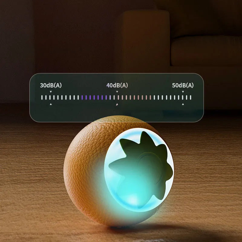 Small green automatic rolling ball toy for dogs and cats on a wooden floor.