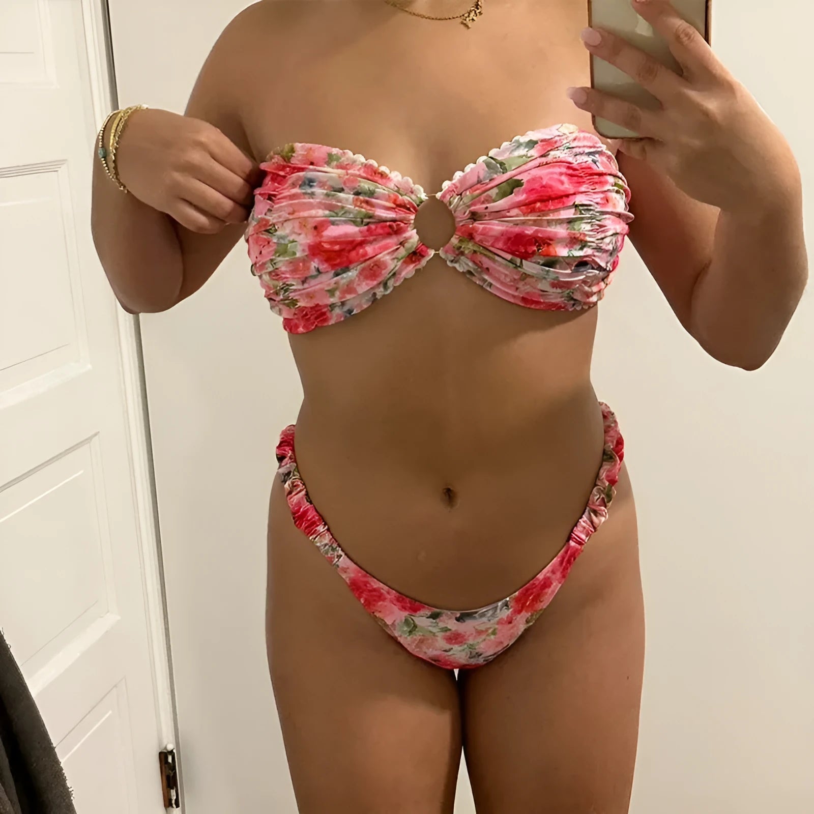 Women's floral print bikini set with lace trim on a backless tube top and matching briefs.