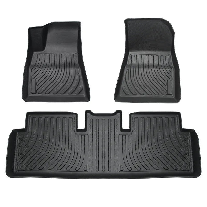 Custom rubber floor mats for Tesla cars, showing TPE footrest section and model-specific contours.