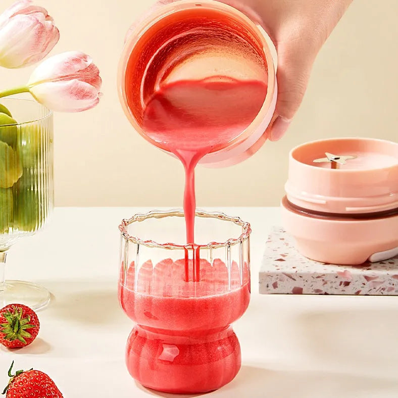 Portable purple rechargeable blender cup with four stainless steel blades, 400ml capacity, shown with USB cable.