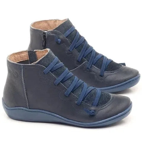 Women's black casual ankle boot with round toe, flat wedge heel, and rubber sole.