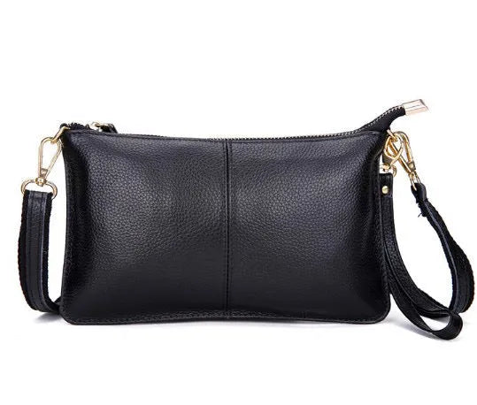 Cowhide ladies slant bag showing internal phone and certificate compartments with hand strap and shoulder strap