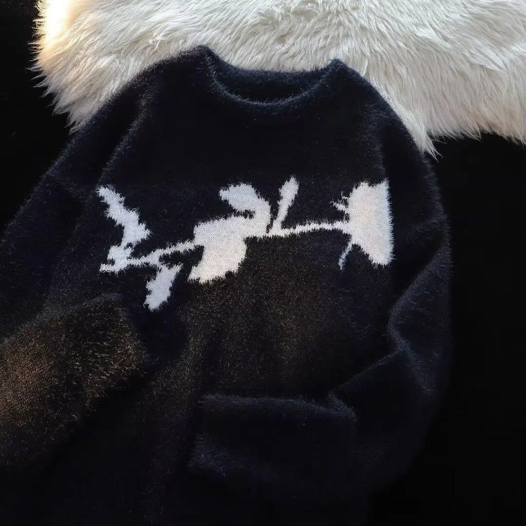 Man wearing a black cotton fleece sweater with a flocking horse and American Dark Rose pattern.