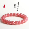 Women's geometric red rhodochrosite crystal bracelet with a longevity lock clasp on a wrist.