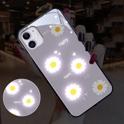 Luminous iPhone case with white daisy design and voice-activated colour lighting on a phone