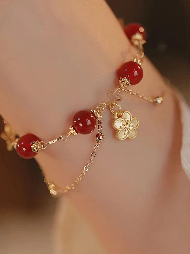 Red agate double layer women's bracelet with floral peach blossom charms on adjustable fastening