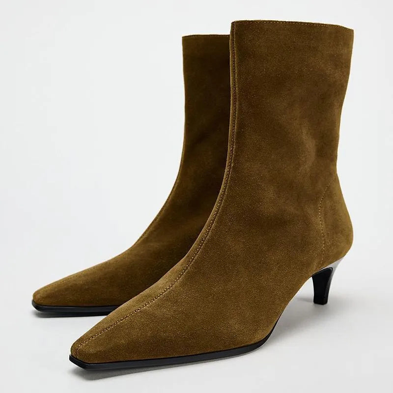 Brown square toe ankle boots with a side zip and a mid kitten heel on a plain background.