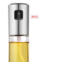 Gold push-type oil and vinegar spray bottle made of ABS plastic and glass with pump top.