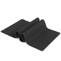 All black extra long desk pad showing overlock stitched edges on a wooden desk.