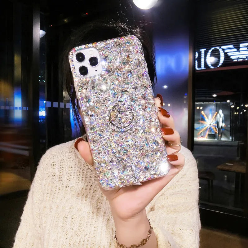 Sparkling diamond acrylic phone case for Samsung Galaxy phone on a table.