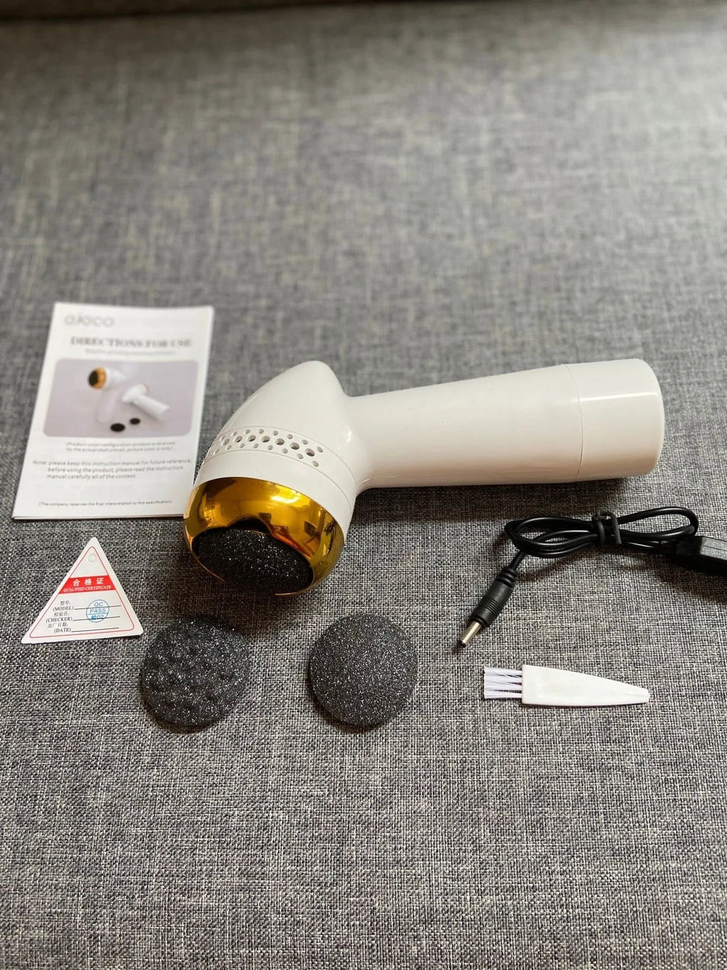 Electric vacuum foot grinder with natural quartz grinding head in gold colour.