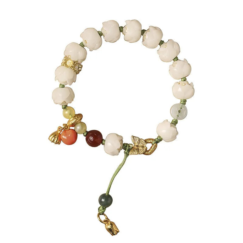 Close-up of a hand-woven white jade Bodhi bracelet with pumpkin and lotus beads on an adjustable rope.