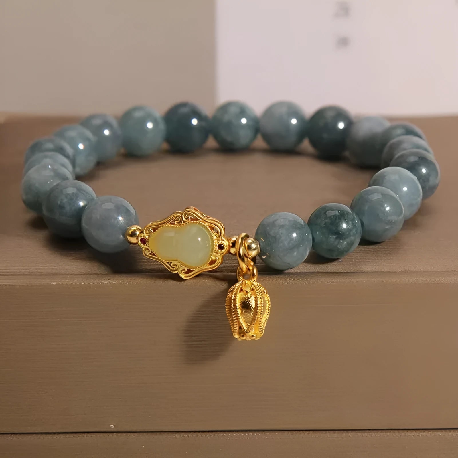 Women's natural stone bracelet with lotus flower gourd pendant in sky blue colour