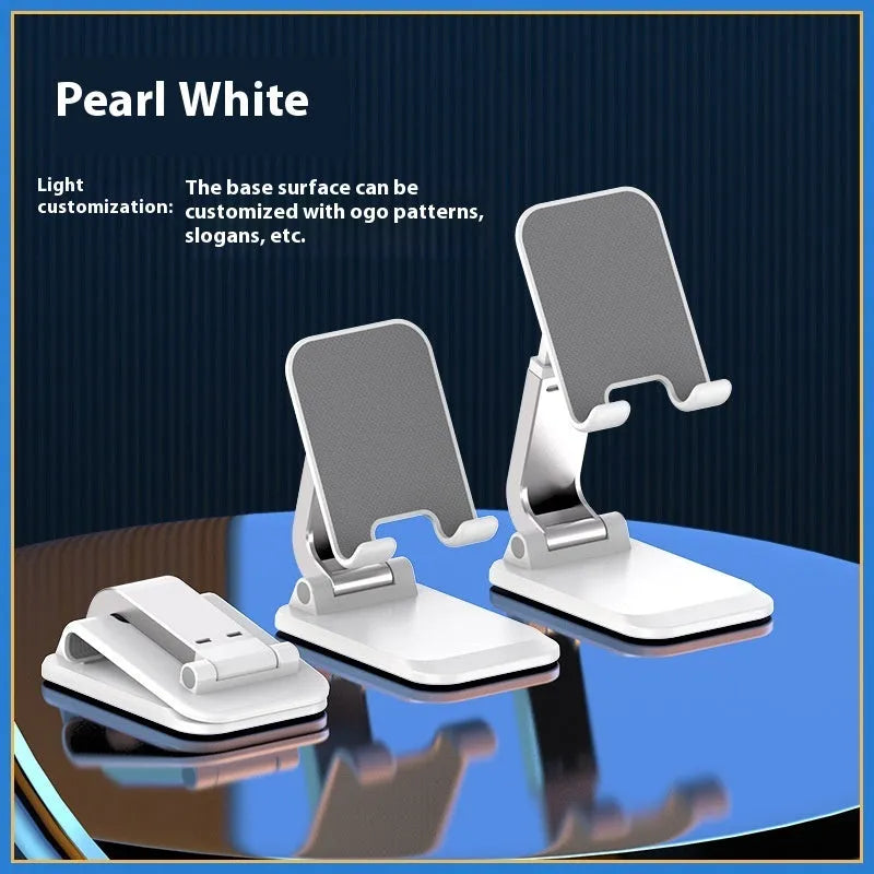 Universal folding portable desktop phone stand in weighted pearl white colour on a wooden table.