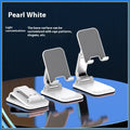 Universal folding portable desktop phone stand in weighted pearl white colour on a wooden table.