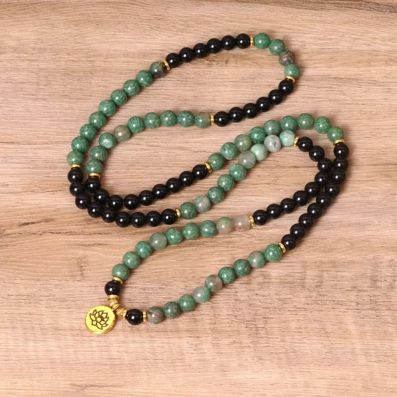 Green and black alloy elastic beaded bracelet with natural styling on wrist
