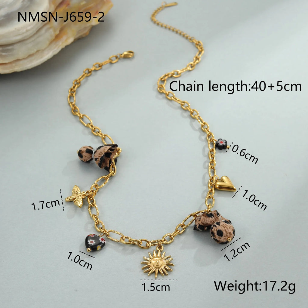 Gold plated stainless steel necklace with geometric leopard, heart, and flowers pendant on adjustable chain
