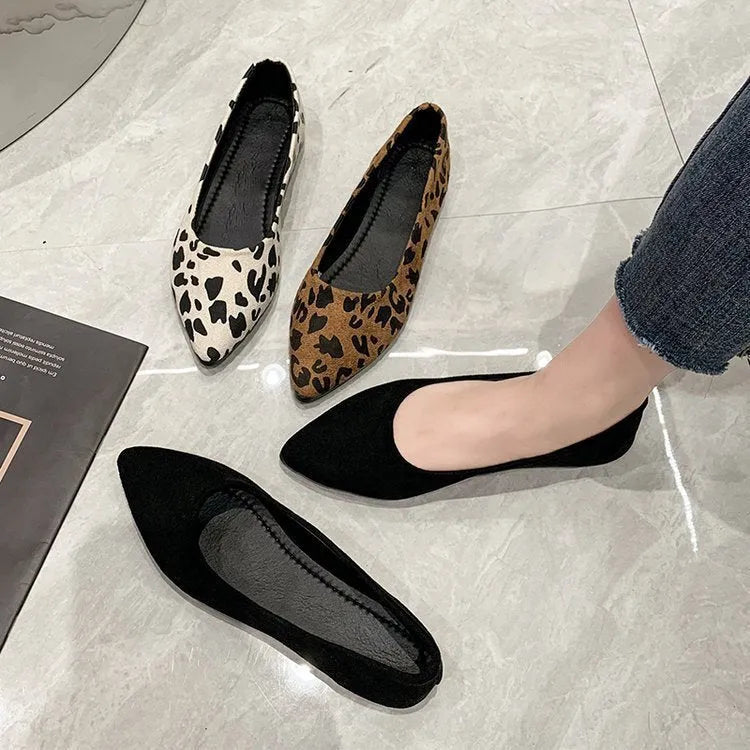 Women's leopard print pointed toe flat pumps with low heel on a white background.