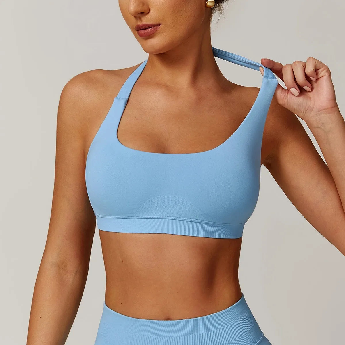Halter neck sports bra for women in nylon, shown in plum purple colour.