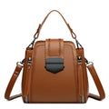 Small square vertical handbag in soft textured PU leather with sewing thread detail.