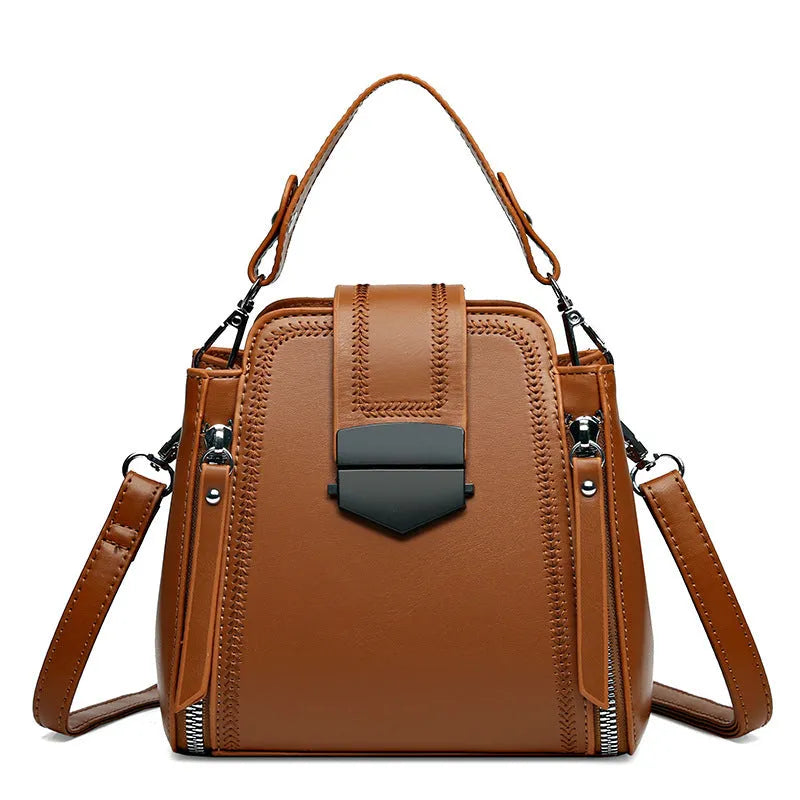 Small square vertical handbag in soft textured PU leather with sewing thread detail.