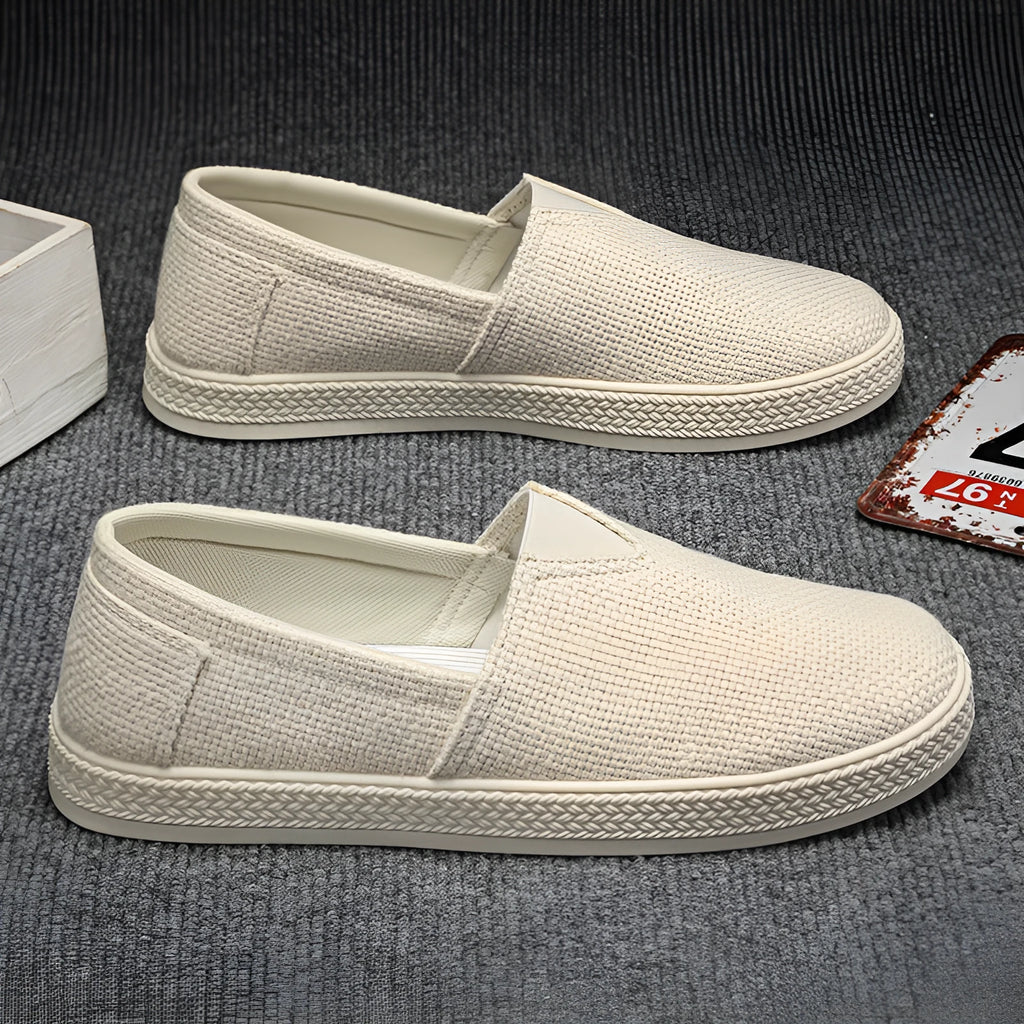 Men's beige linen cloth canvas shoes with round toe and shallow cut on a plain background