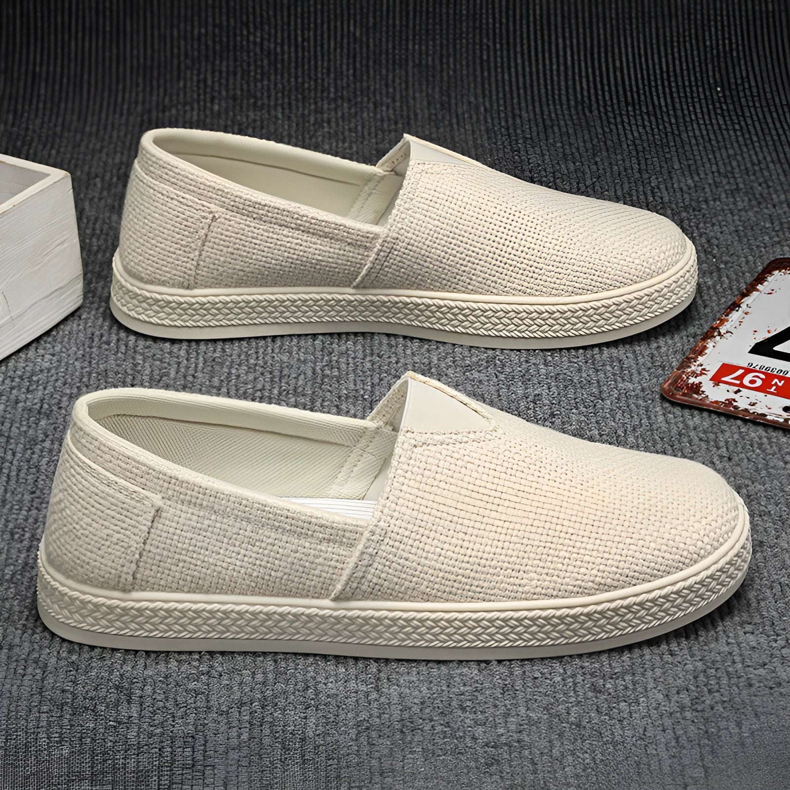 Men's beige linen cloth canvas shoes with round toe and shallow cut on a plain background