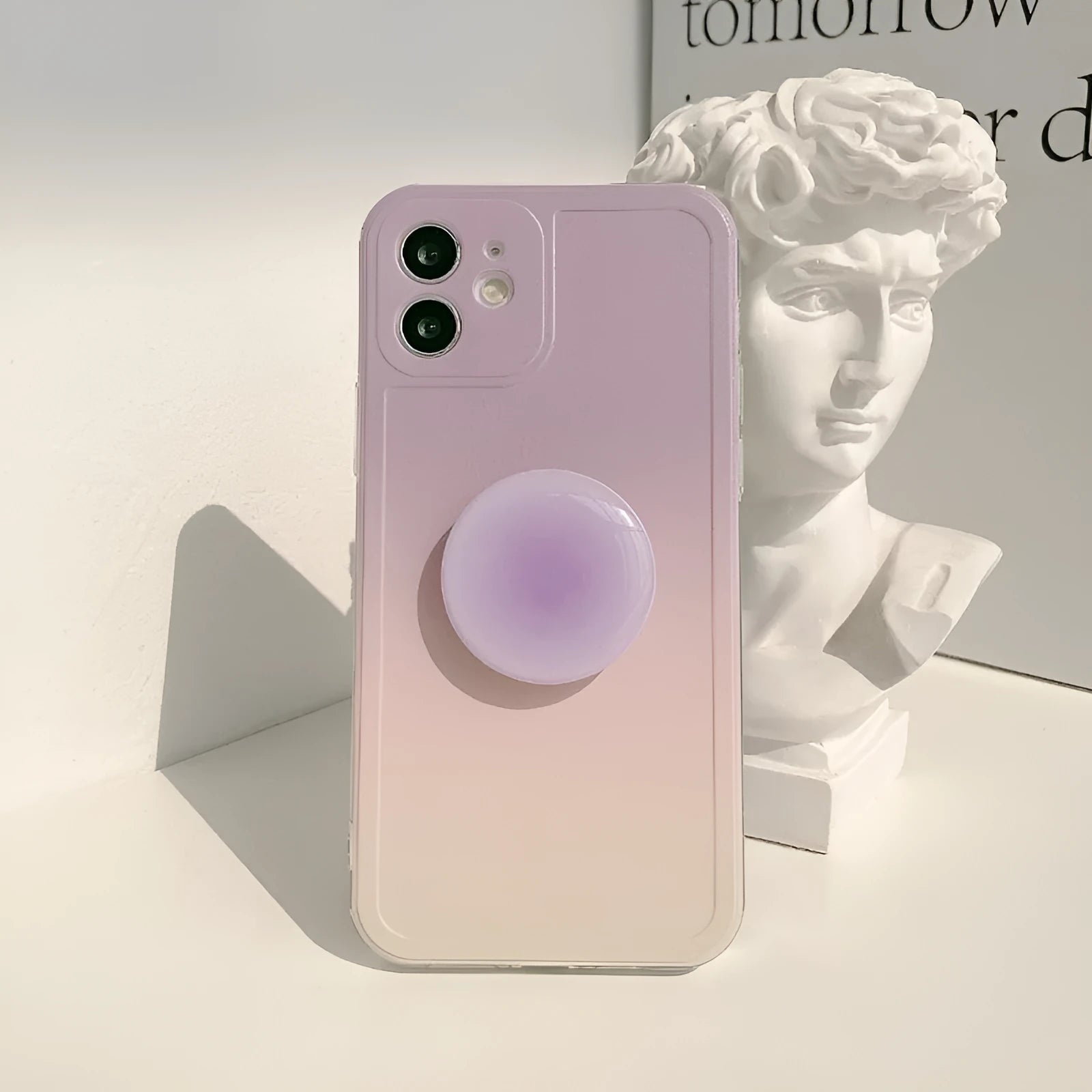 Yellow-purple gradient silicone iPhone case with retractable viewing bracket shown on mobile phone