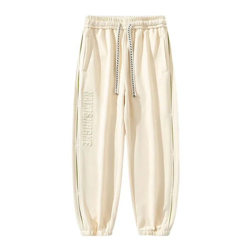 Men's loose cotton trousers with elasticated ankle bands and collage stitching details in khaki colour