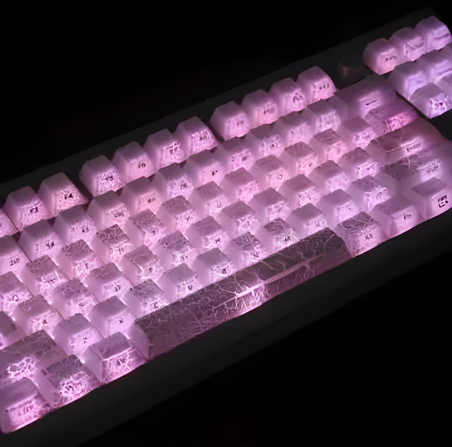 White transparent mechanical keyboard keycap set with side carving details on a dark background.