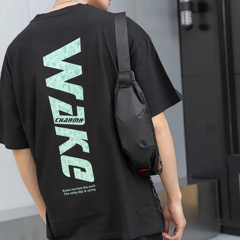Black Oxford cloth crossbody waist pack for men showing front zipper and internal phone pocket.