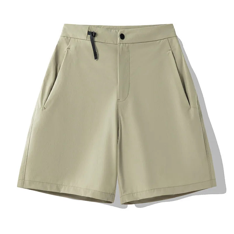 Men's quick-drying sports shorts in khaki colour with 3D cut and elastic waistband on a plain background.