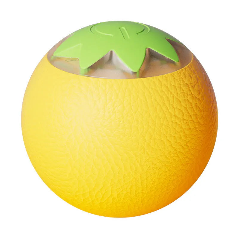 Small green automatic rolling ball toy for dogs and cats on a wooden floor.